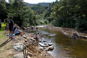 Campers enjoy the sunny weather and swim in the Wentworth River, which this time last year was a raging torrent. Photo / Christine Cornege