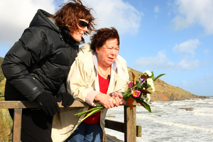 Judith Furlong (right) looks over Sunset Beach, where the remains of her daughter Jane were found in a shallow grave. Photo / Chris Gorman
