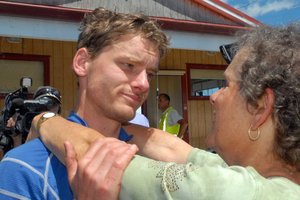 Wellington mountain runner Alastair Shelton hugs his mother Rachel McCahon after spending two days lost in the cold and rain. Photo / Wairarapa Times-Age