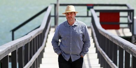 Craig Cooper takes time out to enjoy the sun on Beach Haven Wharf, Auckland. Photo / Steven McNicholl