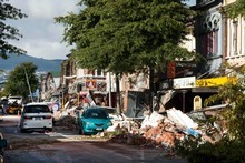 Colombo St suffered heavy damage as building facades collapsed onto the street. Cordons did little to protect people. Photo / Simon Baker
