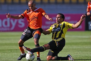 Paul Ifill of the Phoenix tackles Henrique of the Roar. Photo / Getty Images