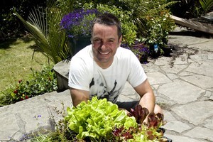 Justin Newcombe with his flourishing garden cube. Photo / Dean Purcell