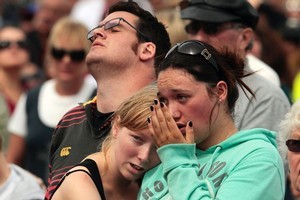 People reflect during two minutes silence at Hagley Park Memorial Service for the one year Christchurch earthquake anniversary. Photo / Getty Images