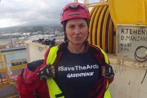 Seven Greenpeace protesters, including Hollywood star Lucy Lawless, clambered onto an Arctic-bound oil drilling vessel and scaled its 53-metre tower at Port Taranaki this morning. Photo / Greenpeace