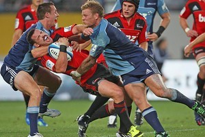 Michael Hobbs of the Blues (L) makes a high tackle on Ryan Crotty of the Crusaders. Photo / Getty Images