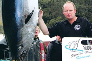 Robbie Lewis with his world record 147kg southern bluefin tuna caught on a 60kg line. He reckons the orca weighed two tonnes. Photo / Gisborne Herald