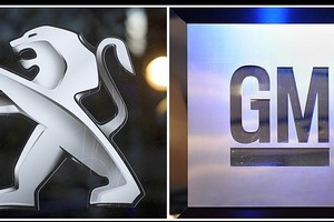 Pictures of the logo of French carmaker PSA Peugeot Citroen (left) and the logo of US giant carmaker General Motors. Photo / AFP
