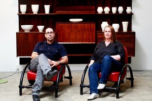 Tim and Natasha English sit in the Ron Arad Rover chairs. Behind their Crown Lynn collection is displayed on a Danish Poul Cadovius interchangeable cabinet. Photo / Steven McNicholl