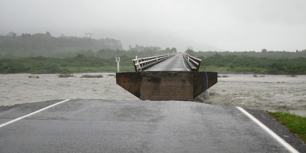 A central section of this bridge near Harihari on the West Coast was carried away by the storm-swollen Wanganui River. Photo / Hokitika Guardian
