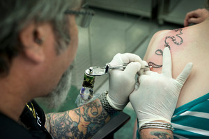 Auckland tattoo artist Steve Waugh says business often surges when a cruise ship is in port. Photo / Natalie Slade