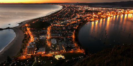 The spectacular view looking down over the main beach at Mt Maunganui at dawn. The Mount is one of the top summer holiday destinations in New Zealand. Photo / Alan Gibson