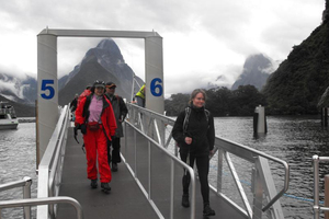 Milford Track trampers arrive back safely at Milford Sound yesterday after experiencing some of worst flooding seen on the track for years. Photo / Olivia Caldwell