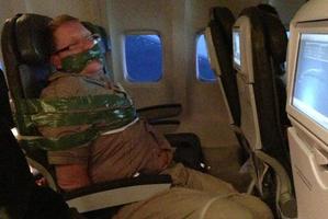 The man was bound and gagged with duct-tape by fellow passenger. The photo taken by a passenger was posted to Andy Ellwood's Tumblr account. Photo / Supplied