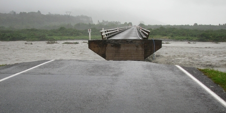 The washed out section of the Wanganui River bridge near Harihari. Photo / Hokitika Guardian