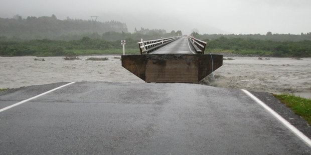 The washed out section of the Wanganui River bridge near Harihari. Photo / Hokitika Guardian