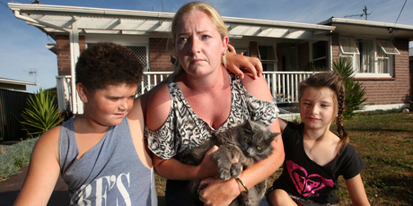 Annette Kelly (centre) and her children Eden McRoy (12, left) and Breana McRoy (7) are keeping Astro locked inside after a spate of suspicious cat deaths. Photo / Ben Fraser