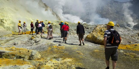 Tourists make their way through the crater of the volcano on White Island. Photo / Alan Gibson