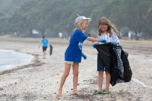 Linnea Quinn and friend Sylvie McDonald, both 7, help to clean up Auckland's Okahu Bay. Photo / Richard Robinson
