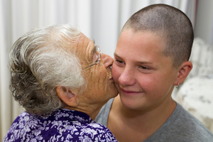 Gemma Singleton gets a hug from her grandmother, Elizabeth Singleton, after former Silver Fern Temepara George cut Gemma's long curly locks off at her school assembly yesterday. Photo / Greg Bowker Gemma Singleton gets a hug from her grandmother, Elizabeth Singleton, after former Silver Fern Temepara George cut Gemma's long curly locks off at her school assembly yesterday. Photo / Greg Bowker