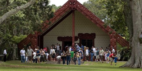 Tourists gather outside Te Whare Runanga at the Waitangi Treaty Grounds in the Bay of Islands. Photo / APN