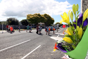 Children walk over the crossing after school which was the were a 12 year old boy on a bike was killed after being hit by a van in Guppy Road. Photo / HBT