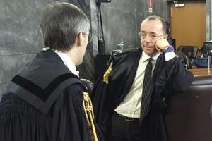Italy Prosecutor Antonio Sangermano, right, talks with Silvio Berlusconi's lawyer Niccolo' Ghedini at the Milan court, Italy. Photo / AP