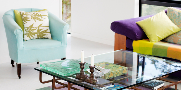 The siting room with purple couch at Susie Flegg and Christine James' house on Waiheke. Photo / Babiche Martens