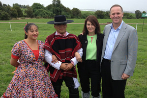 Prime Minister John Key and wife Bronagh pose with Chilean dancers at Fonterra's farm in Chile. Photo / Claire Trevett