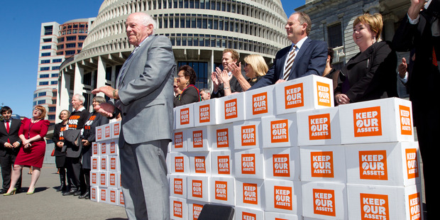 Grey Power president Roy Reid presenting the Keep Our Assets citizens initiated referendum petition to Opposition politicians at Parliament in March. Photo / Mark Mitchell