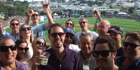 Mark Charlton (centre, rear, raising a glass of wine) turned his apartment into the ultimate corporate box. Photo / Andrew Alderson