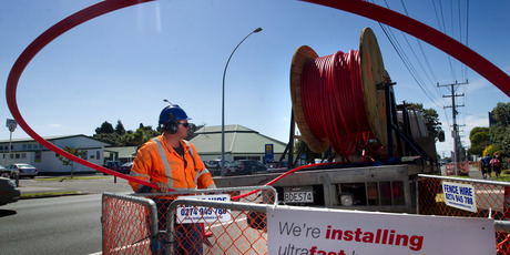 Josh Brown, of Coastal Cabling Services, works to feed ducting for the ultra-fast broadband network into a freshly drilled tunnel in Tauranga. Photo / Alan Gibson
