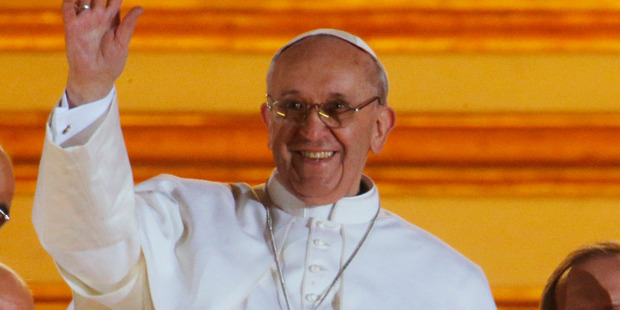Pope Francis waves to the crowd from the central balcony of St. Peter's Basilica at the Vatican. Photo / AP