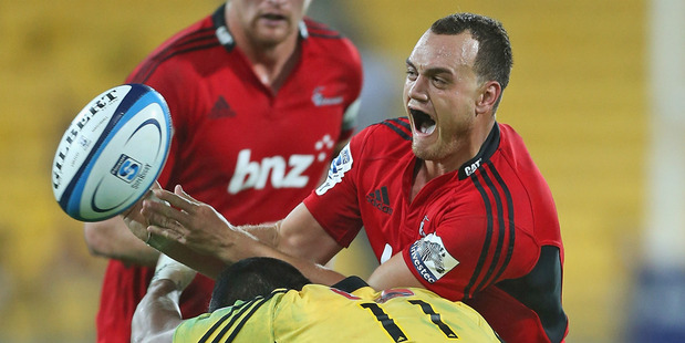 Israel Dagg passes the ball while being tackled by Julian Savea. Photo / Getty Images