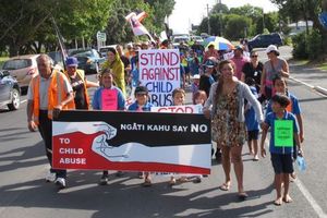 More than 200 people marched through Kaitaia calling for an end to child abuse. Photo / Peter de Graaf