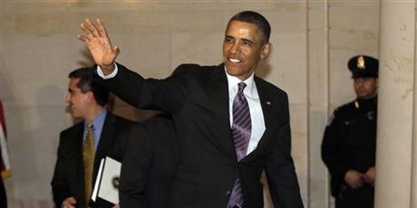 President Barack Obama waves to members of the media as he heads to a meeting with House Democratic Caucus on Capitol Hill in Washington. Photo / AP