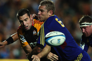 Jarrad Hoeata of the Highlanders tackles Nick Crosswell of the Chiefs during the round six Super Rugby match between the Chiefs and the Highlanders. Photo / Getty Images.