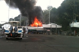 A boat burns at Okahu Bay in Auckland today. Photo / Roger Mills