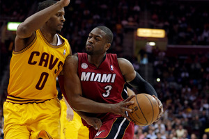 Miami Heat's Dwyane Wade (3) drives past Cleveland Cavaliers' C.J. Miles (0) during the first quarter of an NBA basketball game. Photo / AP.