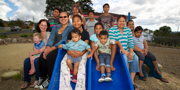 Taurus Cres adults Jenny Keown (left) Lisa Faatele, Nora Lepoalii and Maci Lemeki with local children. Photo / Richard Robinson