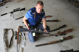 Tim Bonner, Tauranga constable, with the firearms seized after his investigation into a widespread poaching ring. Photo / Bay of Plenty Times