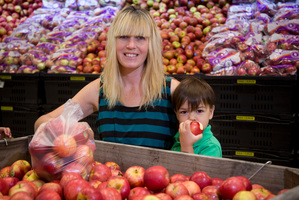 Sandie Speeden, with Micah, 3, took home 5kg of Royal Gala apples for 45c. Photo / John Cowpland