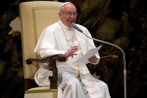 Pope Francis smiles during his message to journalists. He is wearing black shoes rather than papal red ones. Photo / AP
