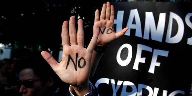 Protesters demonstrate outside Parliament in the Cyprus capital Nicosia. Photo / AP