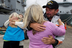 Tania Davies and Steve Jones greet family members at Devonport Naval Base. Photo / Steven McNicholl