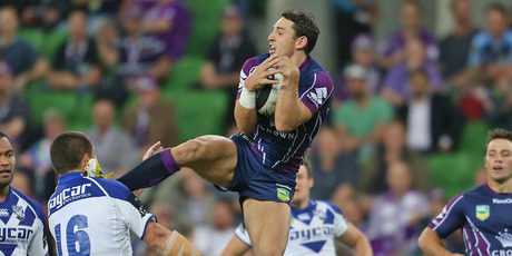Billy Slater of the Storm catches a high ball and kicks David Klemmer of the Bulldogs. Photo / Getty Images