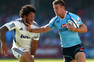 Rob Horne of the Waratahs fends off Rene Ranger of the Blues during the round six Super Rugby match between the Waratahs and the Blues. Photo / Getty Images.
