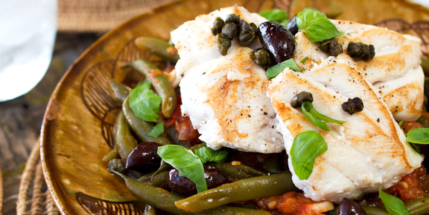 Hapuka medallions with slow-cooked beans. Photo / Babiche Martens