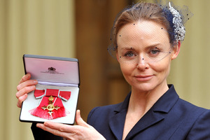 Fashion designer Stella McCartney holds her Officer of the British Empire (OBE) award.Photo / AP