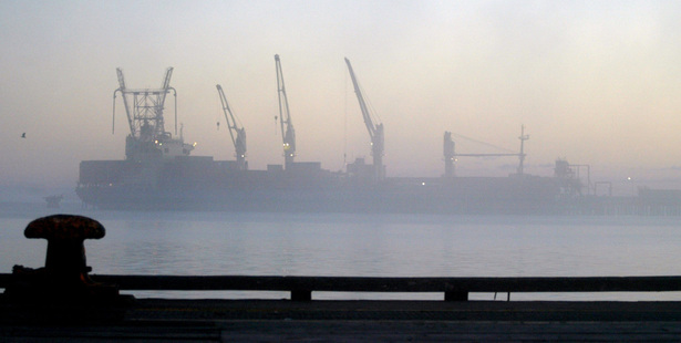 A ship docked at Tiwai Point Aluminium smelter on a cold foggy morning in Bluff. Photograph / Dean Purcell